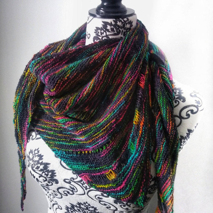 Black and rainbow shawl on a mannequin on a white background