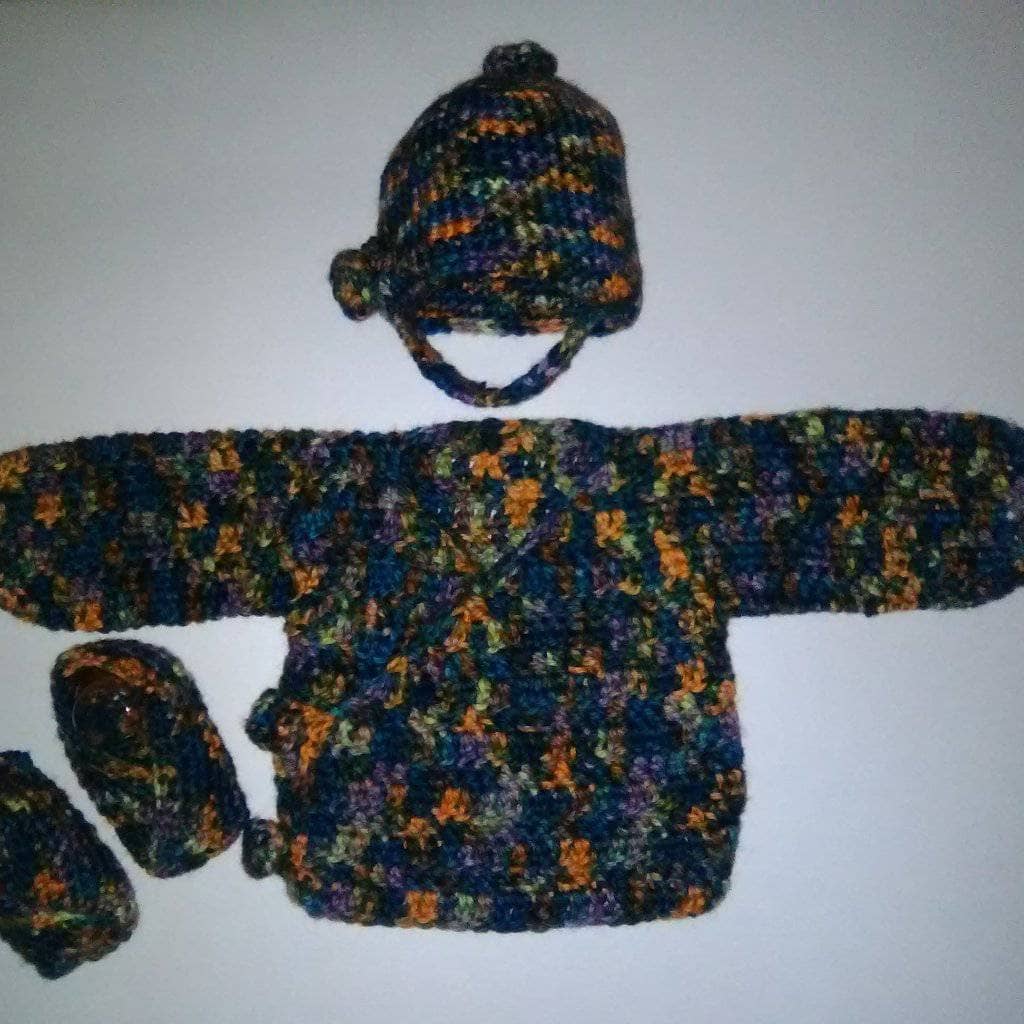 Duster Style Cardigan, with hat and little shoes over a white background