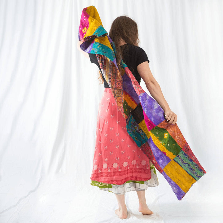 Model holding a One of a Kind Kantha Scarf behind their back. 