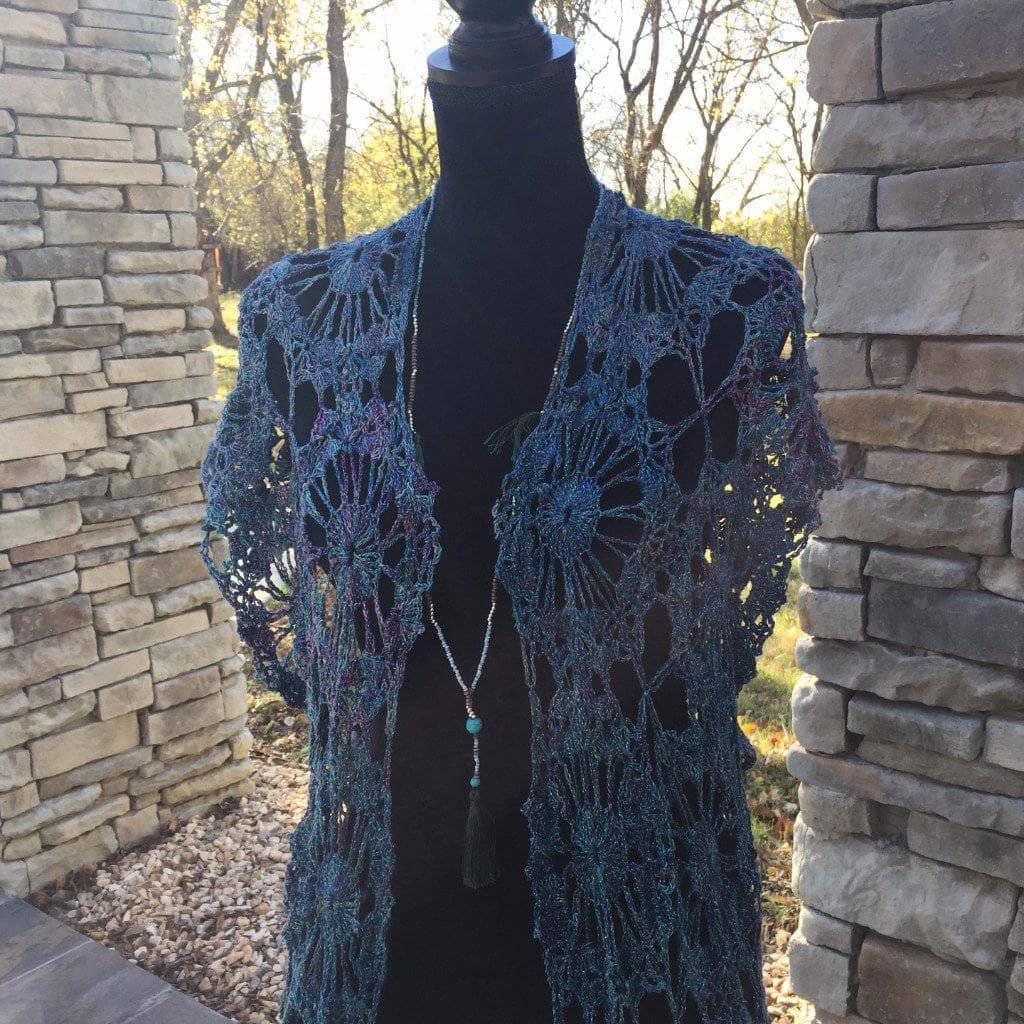 blue poncho over a mannequin outdoors