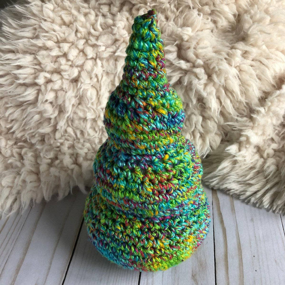 A Christmas tree crocheted from cotton yarn and gold yarn