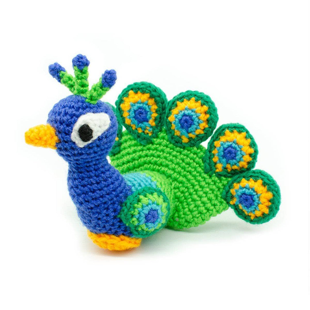 blue, green and yellow peacock amigurumi on a white background