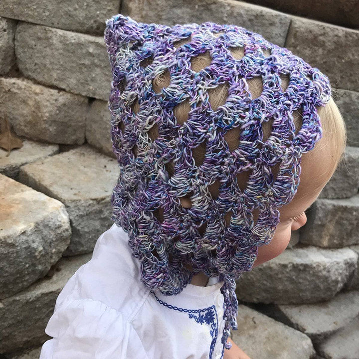 small child wearing a purple beanie