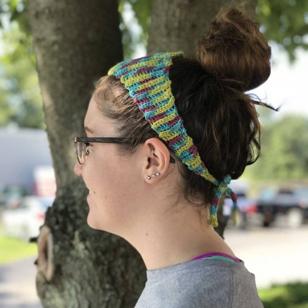 profile of a woman with glasses wearing a colorful headband