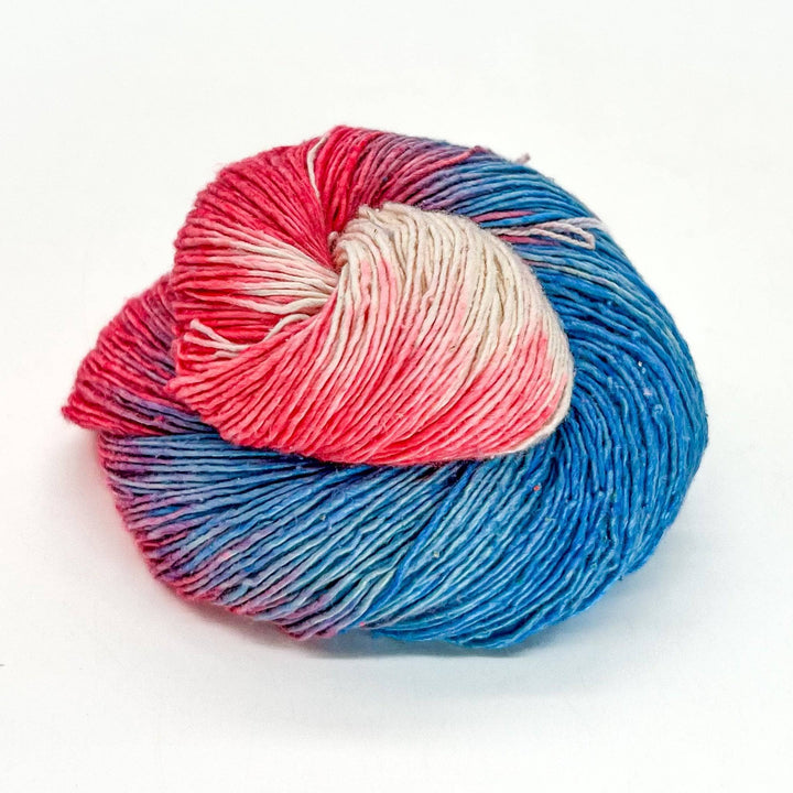 Close up image of sport weight hand dyed pride themed yarn transgender pride flag colors.