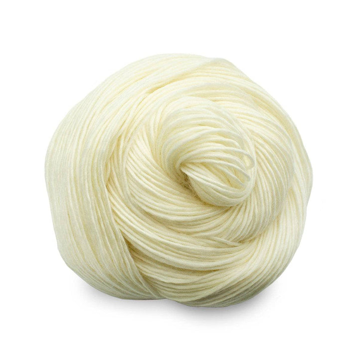 Single skein of pure superwash merino wool yarn (undyed) in front of a white background
