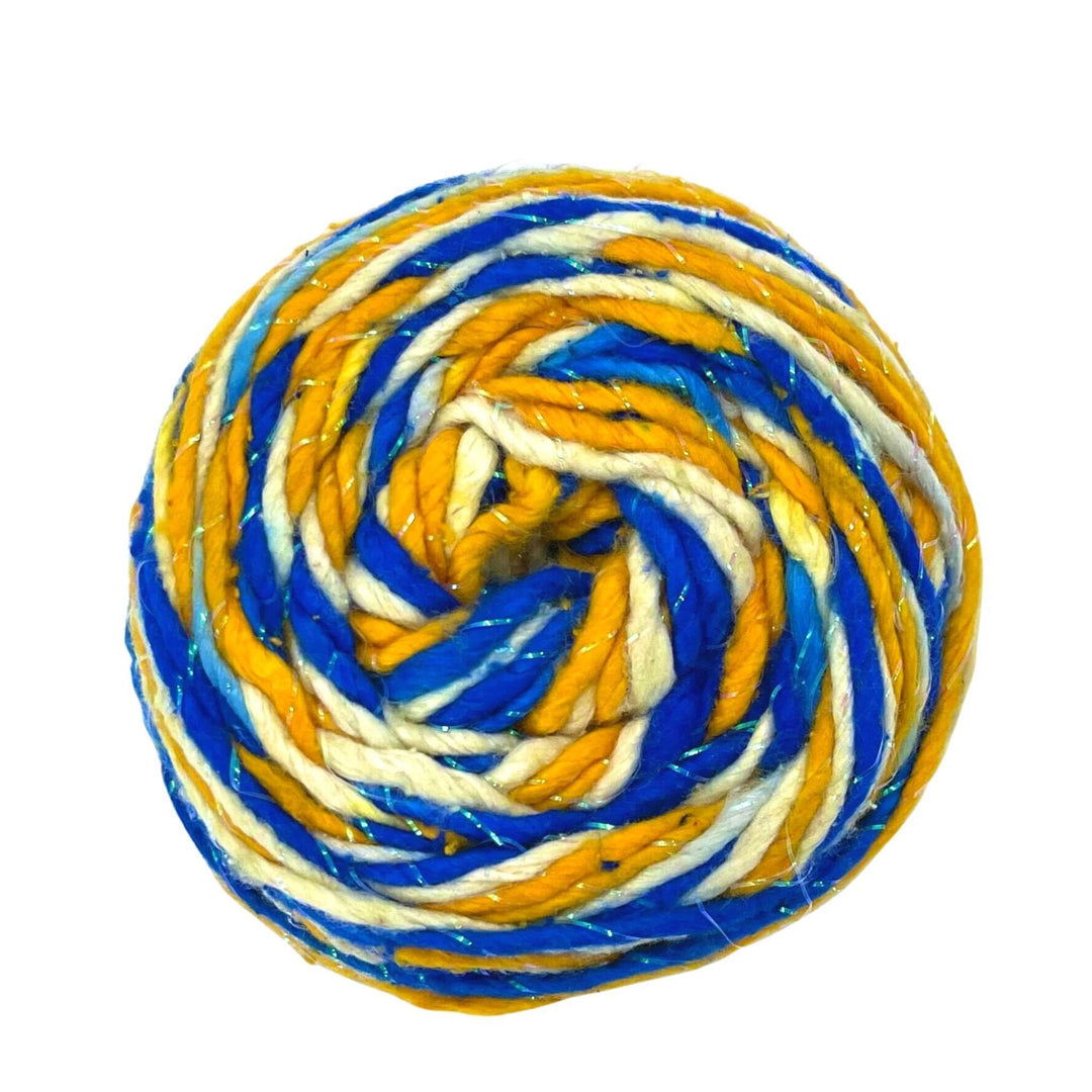 a skein of reclaimed silk yarn in the colors blue, yellow and white with sparkle on a white background