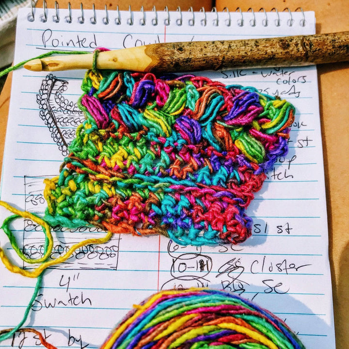 in progress image of a rainbow cowl on a crochet hook