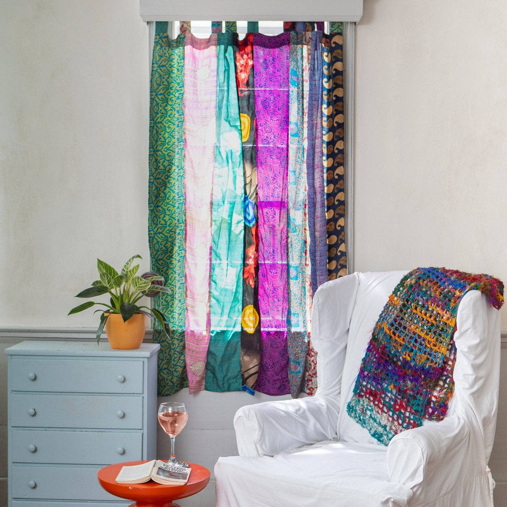 A one of a kind recycled sari drape hanging in a window
