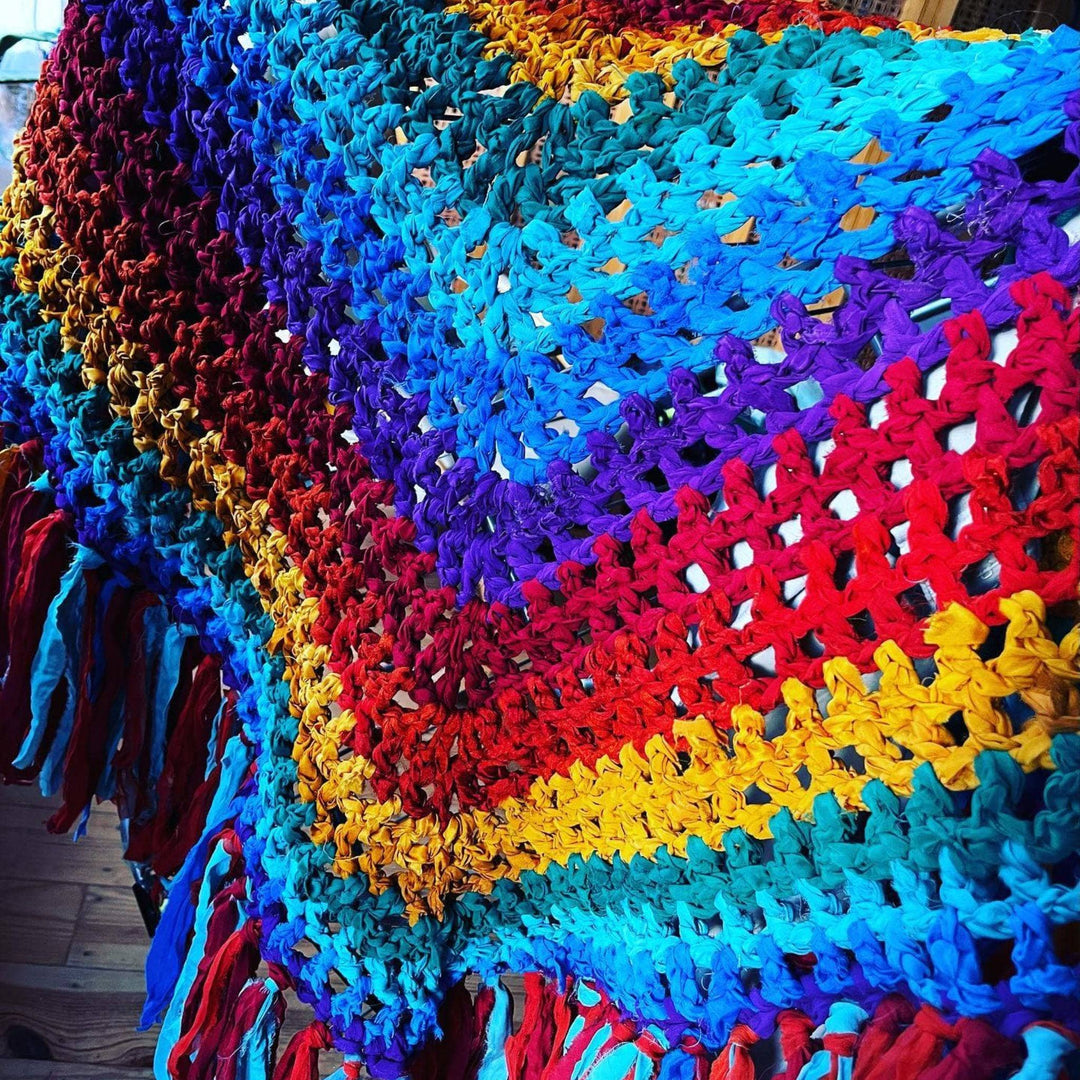 An up close photo of a completed rainbow Shawl