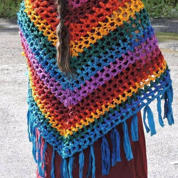 back of a woman wearing a rainbow shawl