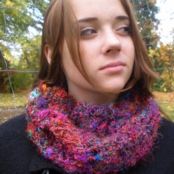 Girl looking to the side, wearing a multicolored scarf