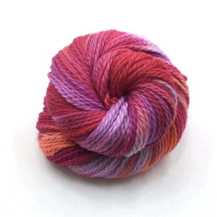 Aran twisted wool yarn in Raspberry (pinks) on a white background