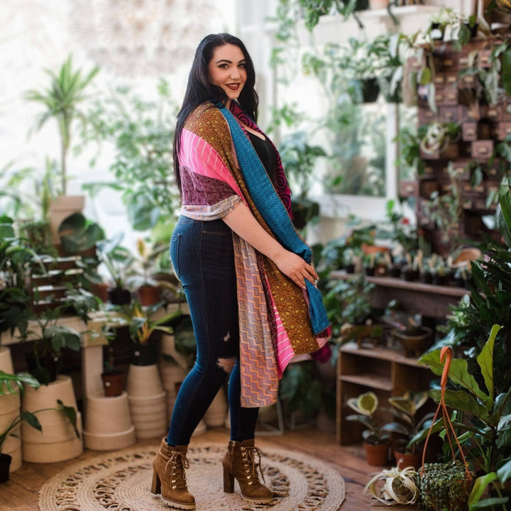 Woman standing in front of a room of plants wearing the sari scarf on her shoulders