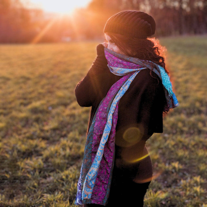 Woman wearing a medley scarf around her neck in the sunshine