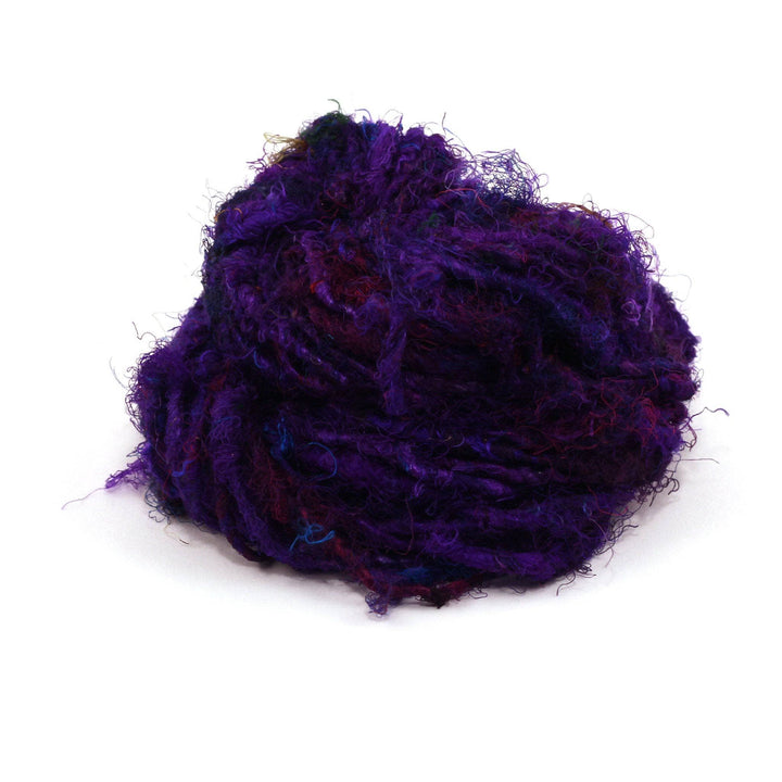  Recycled Silk Yarn close up in the color "Indigo Amethyst," a rich royal purple, with a white background