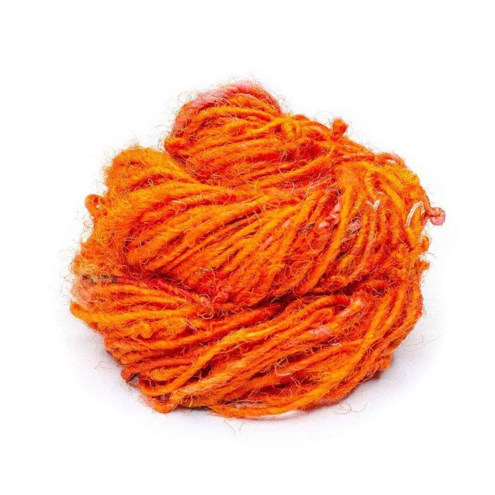 Recycled Silk Handspun Yarn "Lux Adventure" in the color "Pumpkin Pie," a vibrant orange hue.
