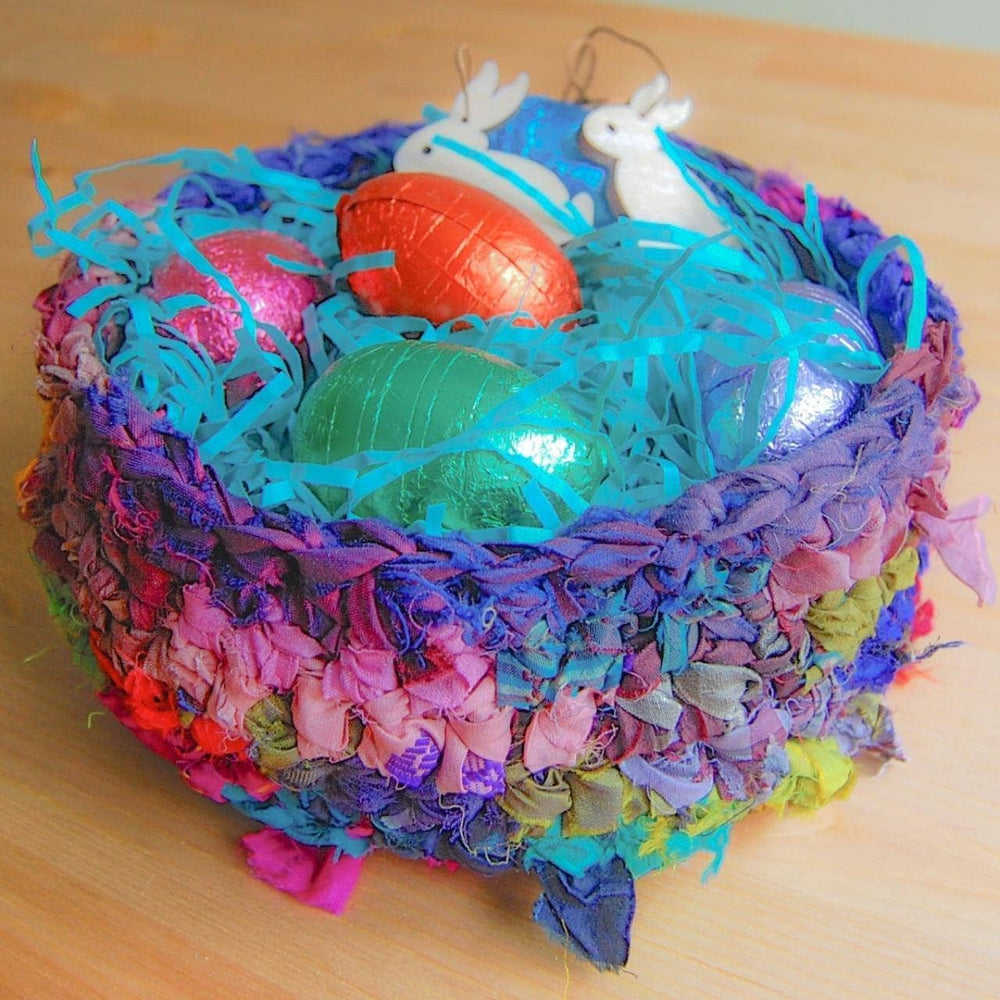 colorful basket of ribbon yarn with confetti and easter eggs inside
