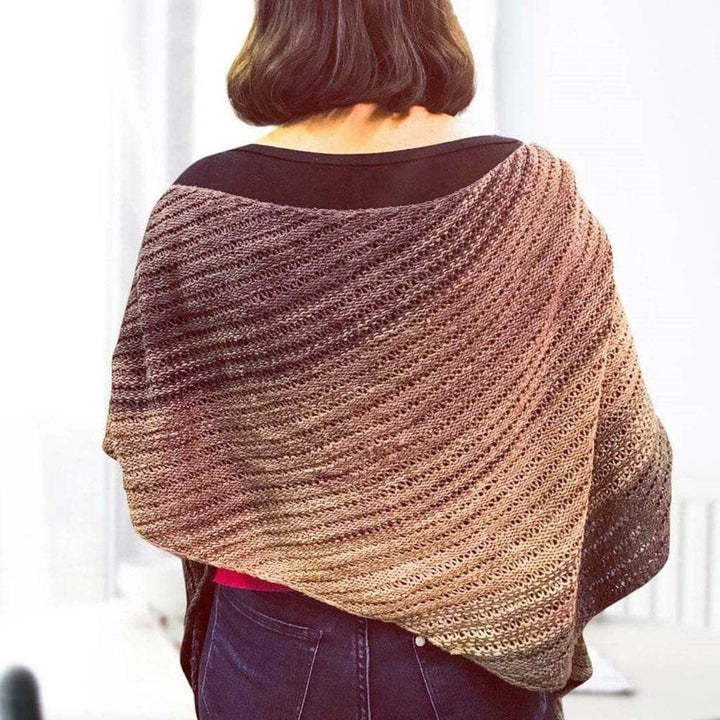 Back view of model wearing stormy night recycled silk shawl in front of a white background.