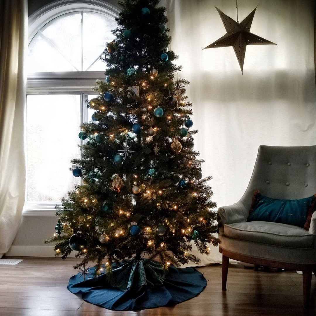 Christmas tree with a blue tree skirt around it