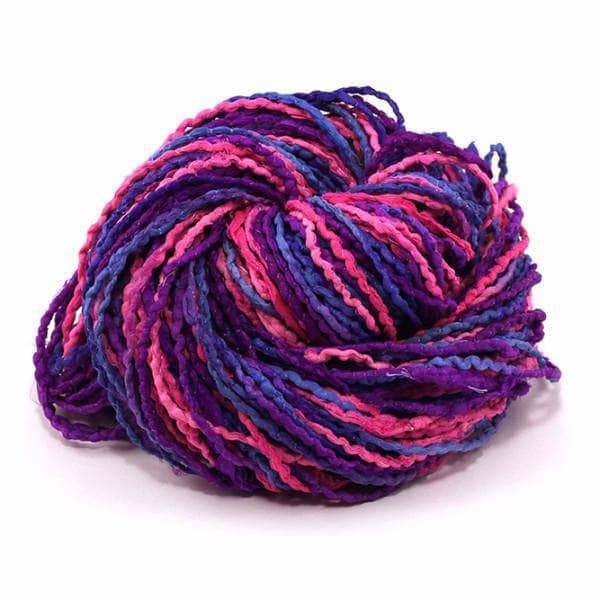 A skein of pink and purple corded ribbon on a white background
