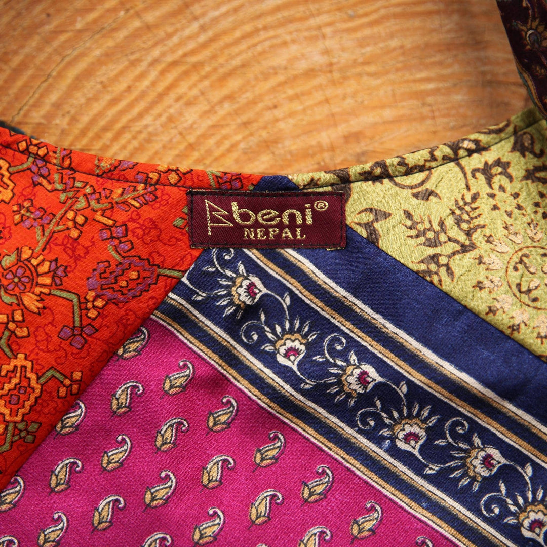 An up-close photo of a Sari Silk Purse, showing the detail of the stitching and the different patterns