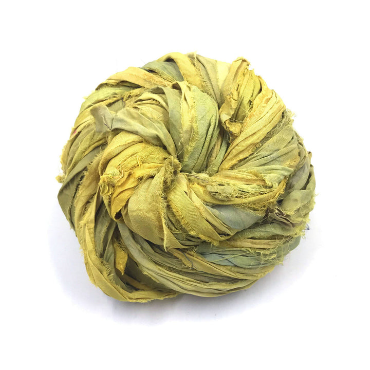 A skein of yellow ribbon yarn on a white background