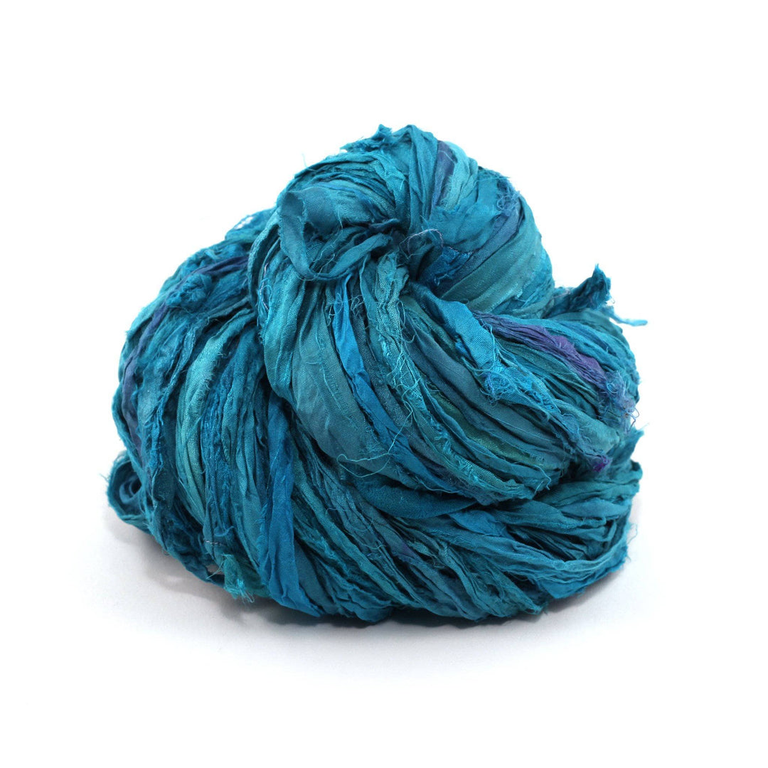 A skein of blue ribbon yarn on a white background