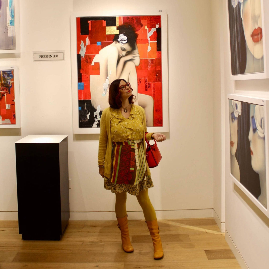 Artist Deanna Bowers is standing in an artist museum wearing a mini striped sari wrap skirt. 