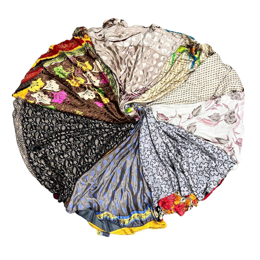 Color wheel made up of neutral tone sari wrap skirt on a white background. 