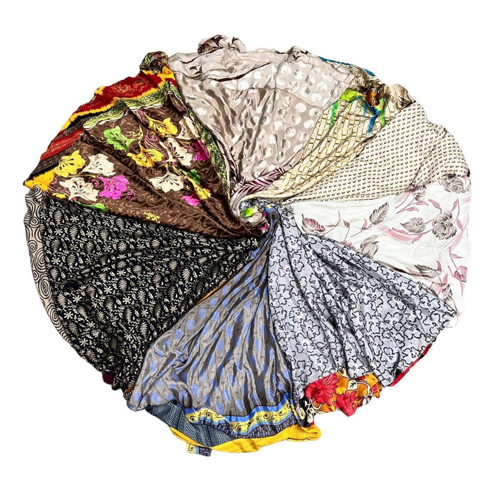 Color wheel made up of neutral tone sari wrap skirt on a white background. 