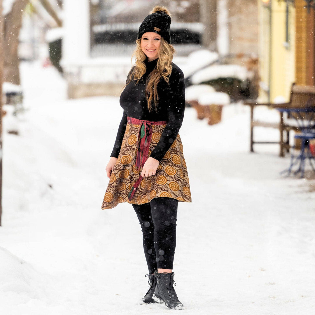 Woman in a short wrap skirt enjoying a snowy winter day.