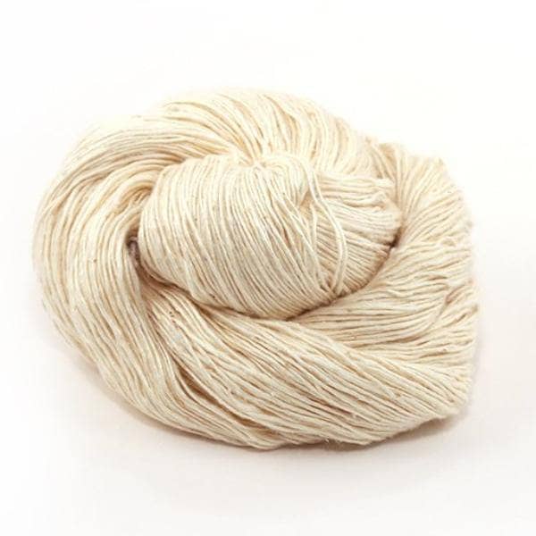 skein of white lace weight silk in front of a white background.