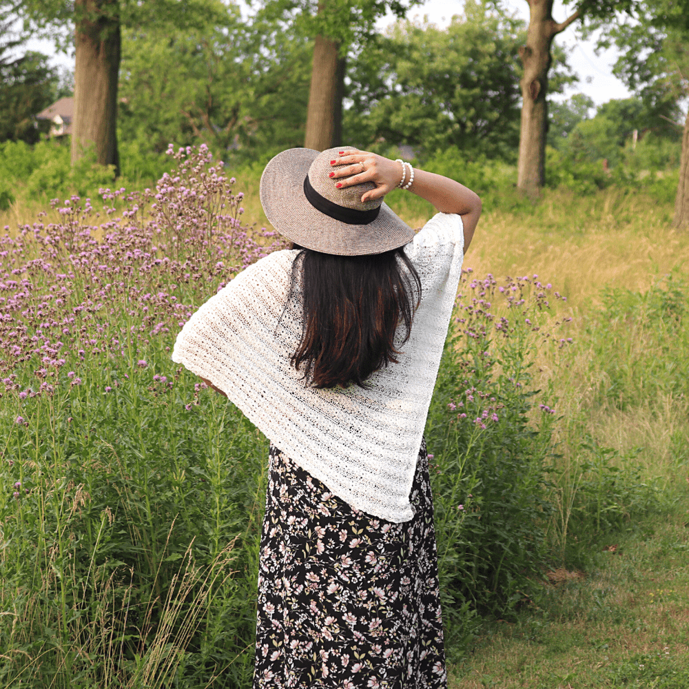 womens standing outside wearing a white poncho