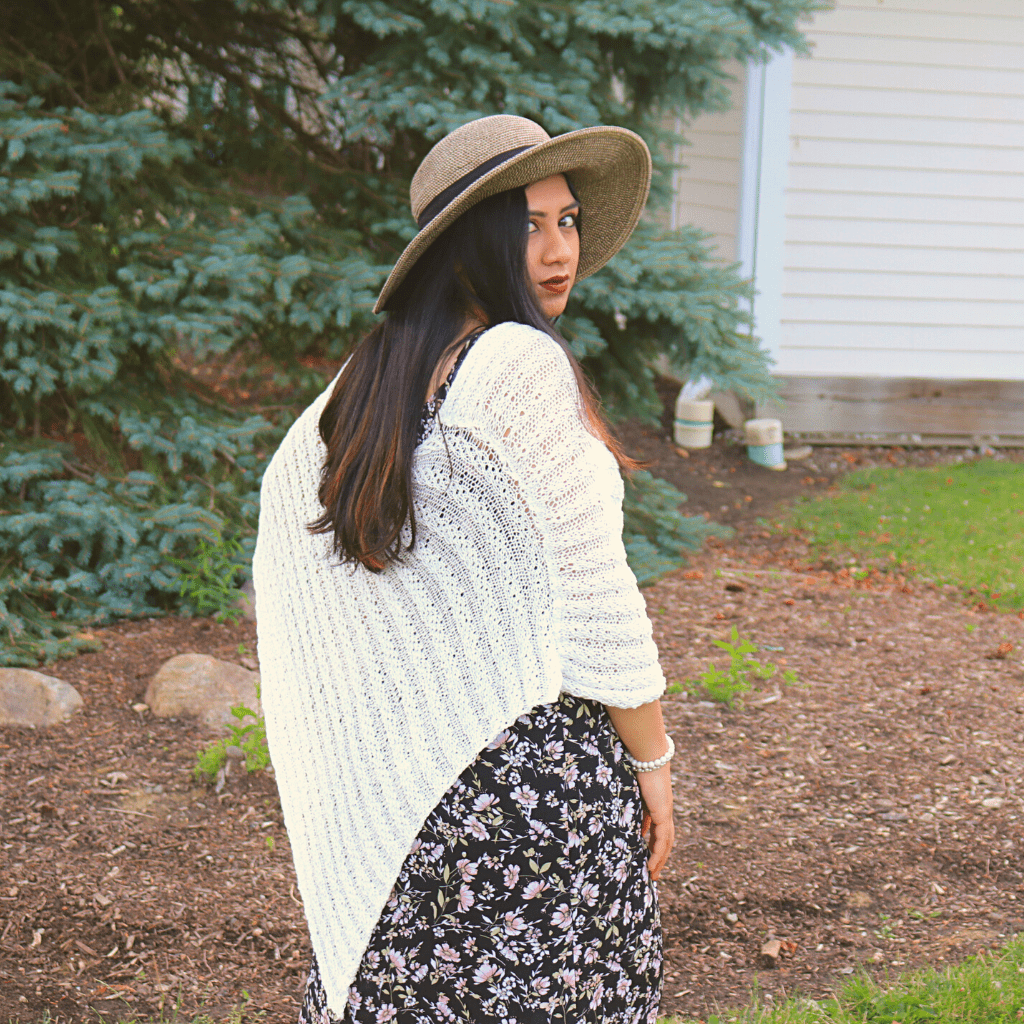womens standing outside wearing a white poncho