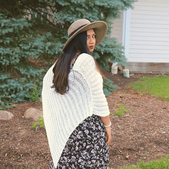 womens standing outside wearing a white poncho