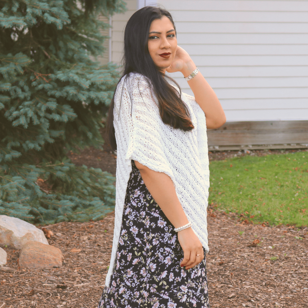 womens standing outside wearing a white poncho