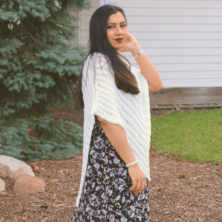 womens standing outside wearing a white poncho