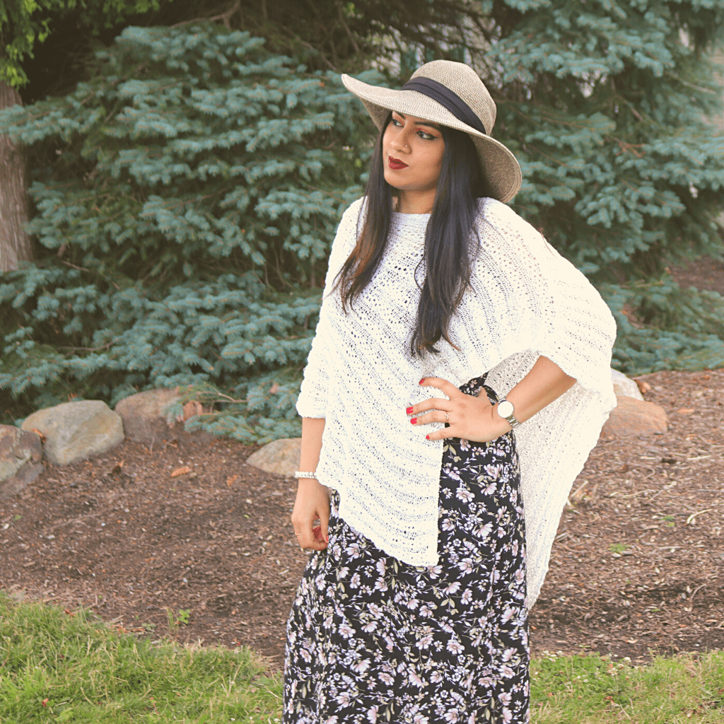 womens standing outside wearing a white poncho