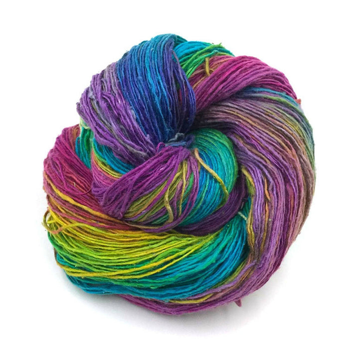 skein of vibrant variegated rainbow lace weight yarn in front of a white background. 