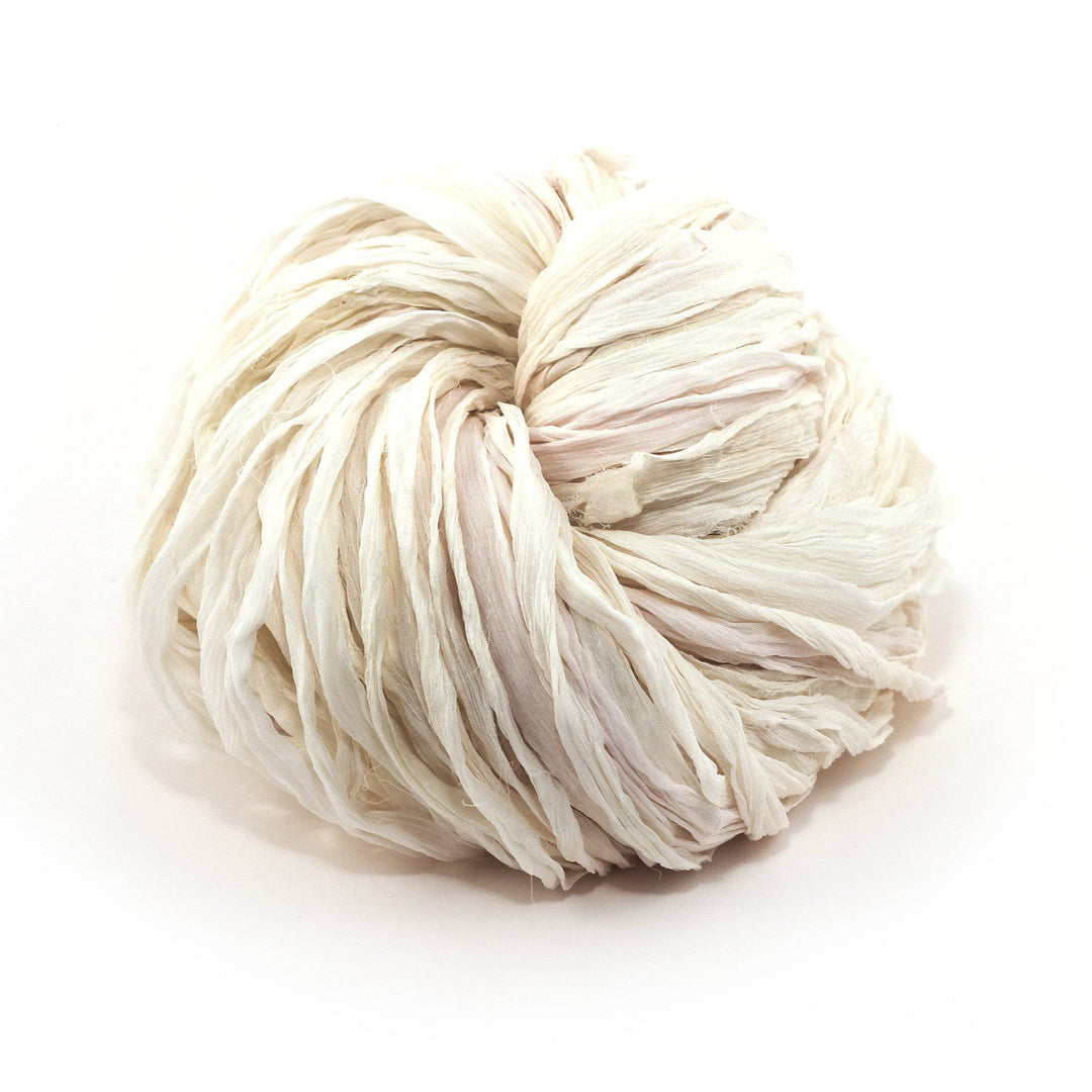 A skein of white ribbon yarn on a white background