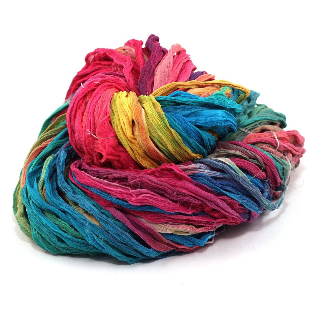 A skein of multicolored ribbon yarn on a white background