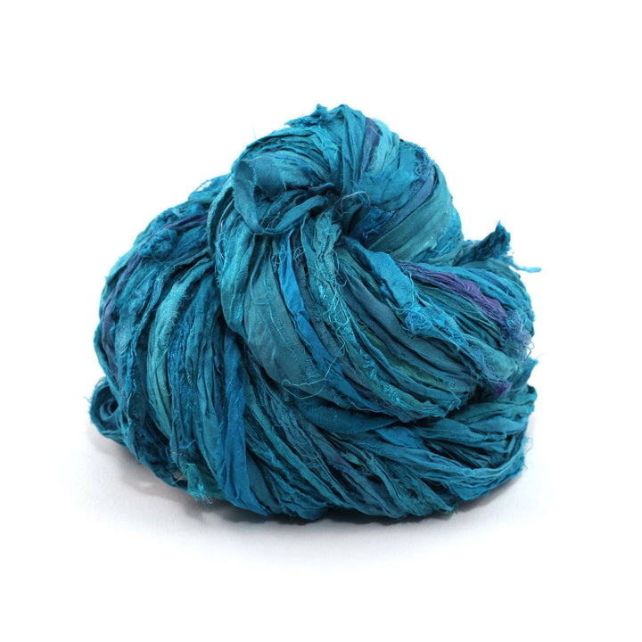 teal cake of yarn in a white background