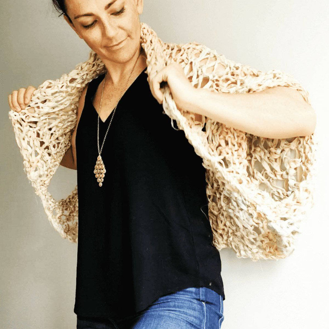 woman wearing a beige Lace Summer Cocoon Coat with a black shirt and blue jeans