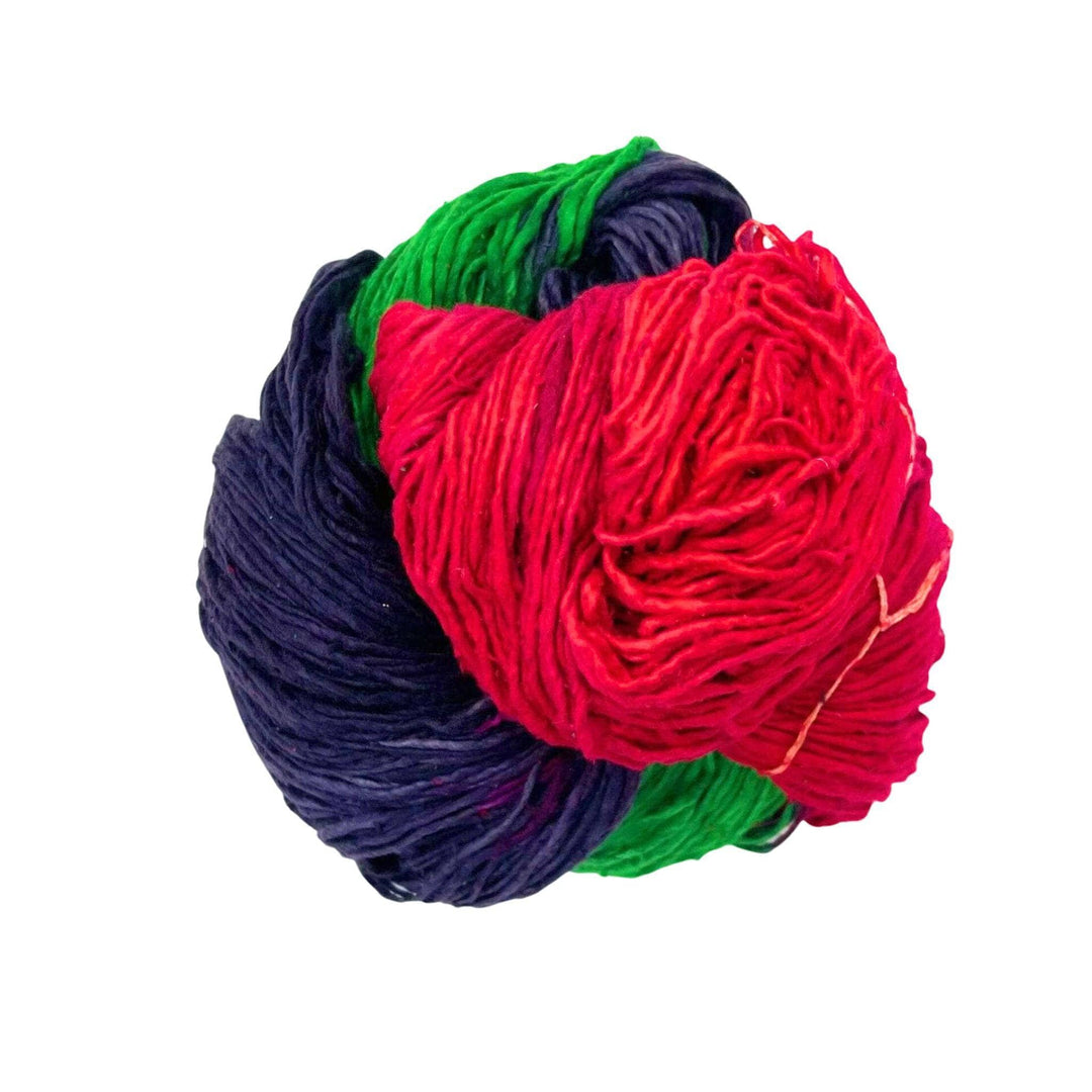 Green, black, and red worsted weight yarn on a white background