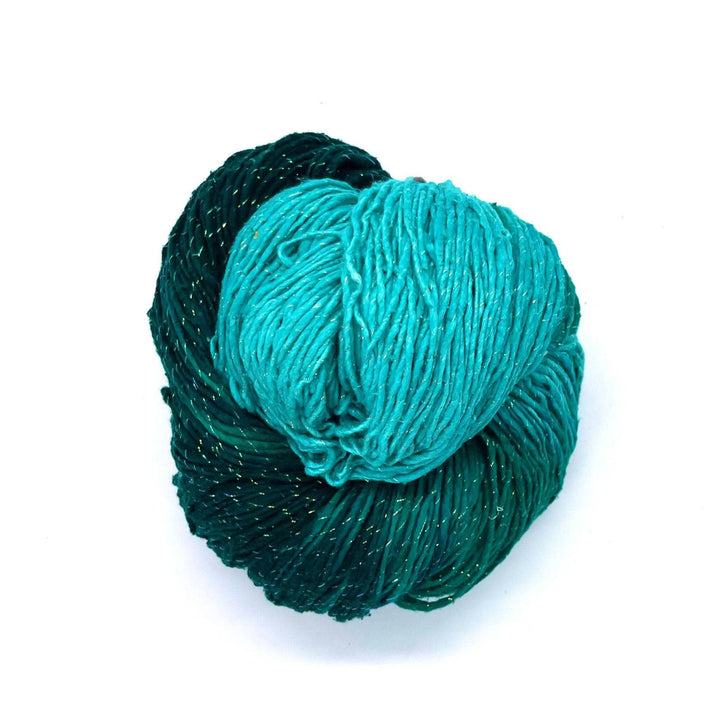 Light and Dark Green with sparkles worsted weight yarn on a white background