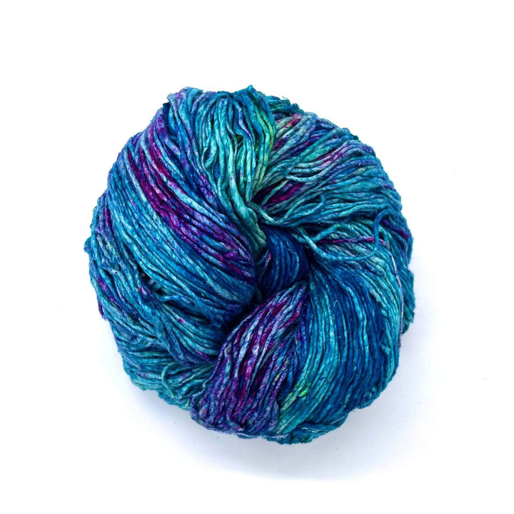 Teal, Green, and light blue worsted weight yarn on a white background