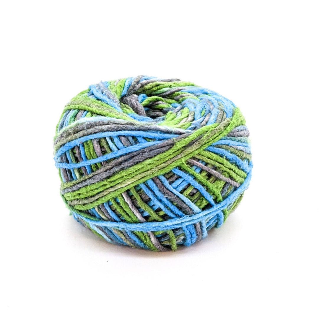 Silk roving worsted weight yarn in cornflower bloom in front of a white background.