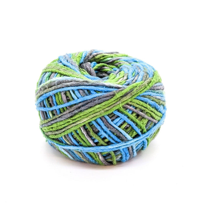 Silk roving worsted weight yarn in cornflower bloom in front of a white background.
