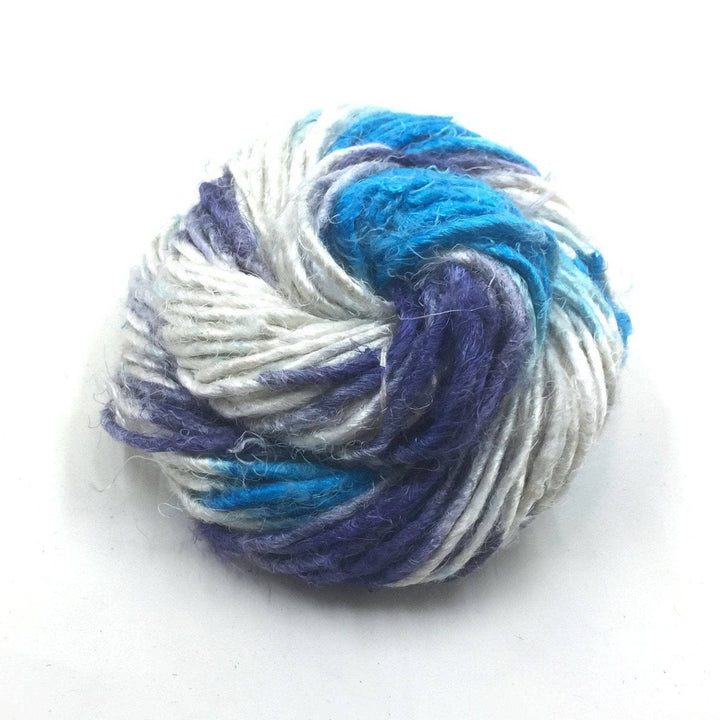 Banana Fiber Yarn donut ball in Ikat Indigo (blues, gray) on a white background